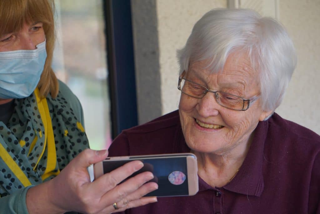 An older woman looking at a smartphone