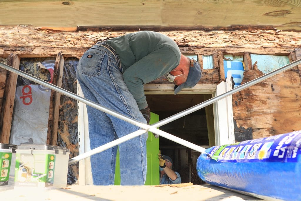 A team installing a door at a house