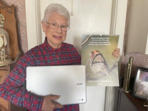Norma Conway is delighted by the Chromebook and beautiful calendar she received from HAH this Holiday season