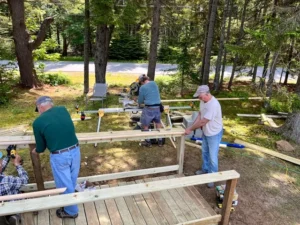 Members of the home repairs team build a ramp at the home of Juliana and Jim Gaudet.