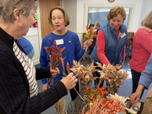 Participants in a 2022 Friends Together program create dried-flower arrangements with guidance from the Harpswell Garden Club. (Lili Ott photo)
